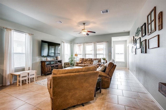 tiled living room featuring vaulted ceiling and ceiling fan