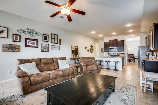 tiled living room featuring ceiling fan