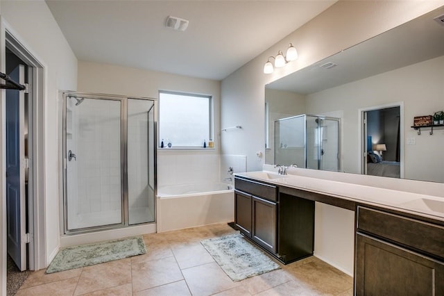 bathroom with tile patterned flooring, vanity, and shower with separate bathtub