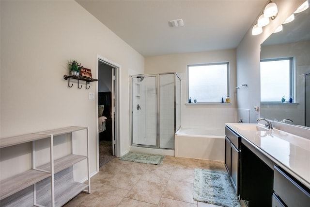 bathroom featuring tile patterned floors, vanity, and a washtub