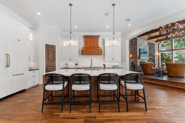 kitchen featuring white cabinets, hanging light fixtures, and a spacious island