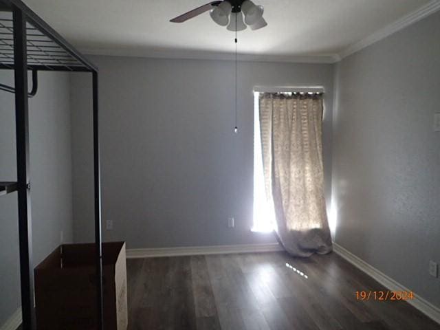 unfurnished living room featuring ceiling fan, crown molding, and dark wood-type flooring