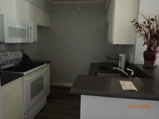 kitchen featuring white cabinetry, sink, white appliances, and ornamental molding