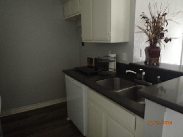 kitchen featuring white cabinetry, sink, and dark wood-type flooring