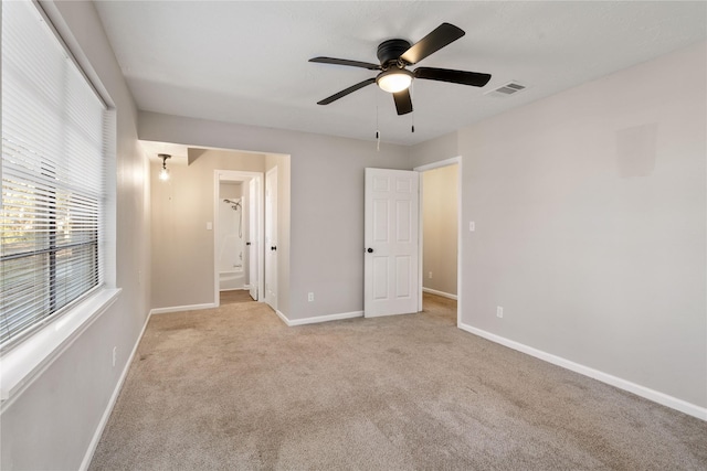 unfurnished bedroom featuring light carpet and ceiling fan