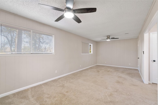 unfurnished room with light carpet, a textured ceiling, and ceiling fan