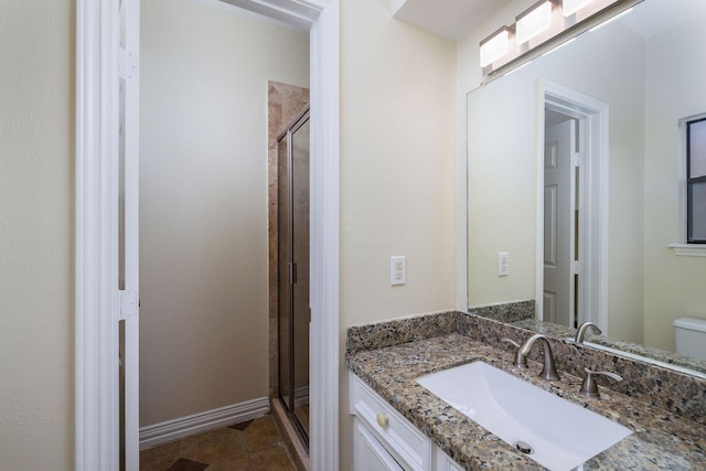 bathroom with tile patterned flooring, a shower with door, vanity, and toilet