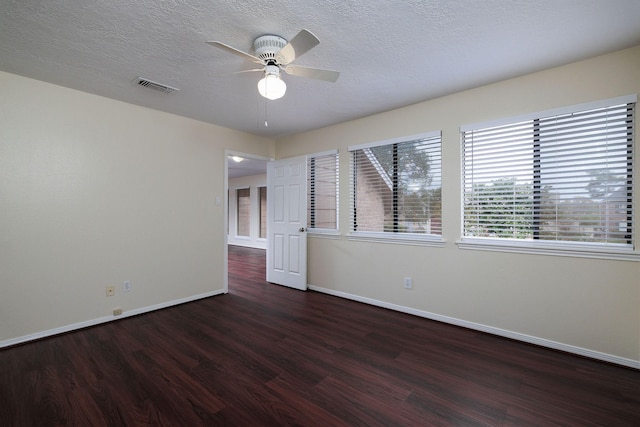 spare room featuring a textured ceiling, dark hardwood / wood-style flooring, and ceiling fan