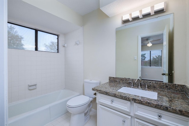 full bathroom featuring ceiling fan, tile patterned floors, toilet, vanity, and tiled shower / bath