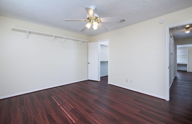 unfurnished bedroom featuring a textured ceiling, ceiling fan, a closet, and dark hardwood / wood-style floors