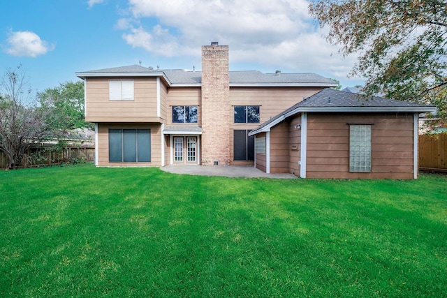 rear view of property featuring a yard and a patio area