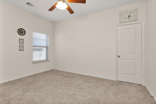 empty room with ceiling fan and light colored carpet