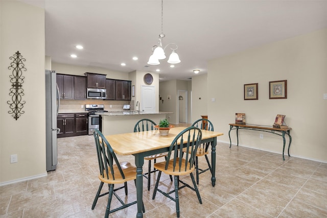 dining room with sink and an inviting chandelier