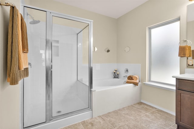 bathroom with tile patterned floors, vanity, and independent shower and bath