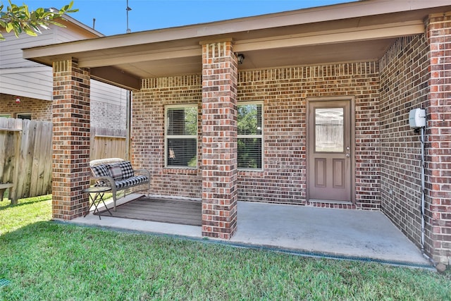 view of exterior entry with a yard