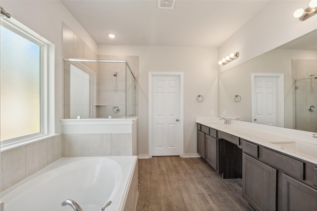 347 Bay Oaks St, La Porte, TX 77571 - bathroom with a shower stall, double vanity, a garden tub, and wood finished floors