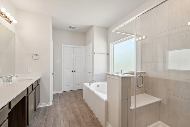 347 Bay Oaks St, La Porte, TX 77571 - full bath featuring vanity, a bath, wood finished floors, and a shower stall