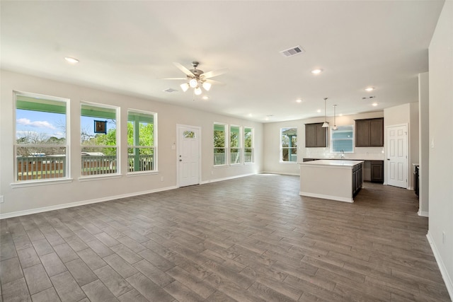 347 Bay Oaks St, La Porte, TX 77571 - unfurnished living room featuring a ceiling fan, dark wood finished floors, healthy amount of natural light, and recessed lighting