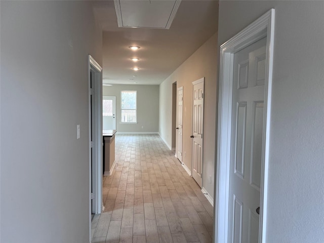 corridor with light wood-type flooring