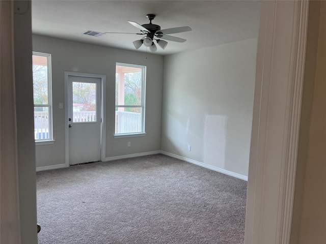 unfurnished room featuring light carpet and ceiling fan