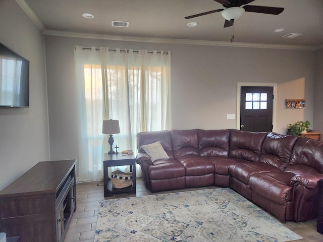 living room with ceiling fan and crown molding