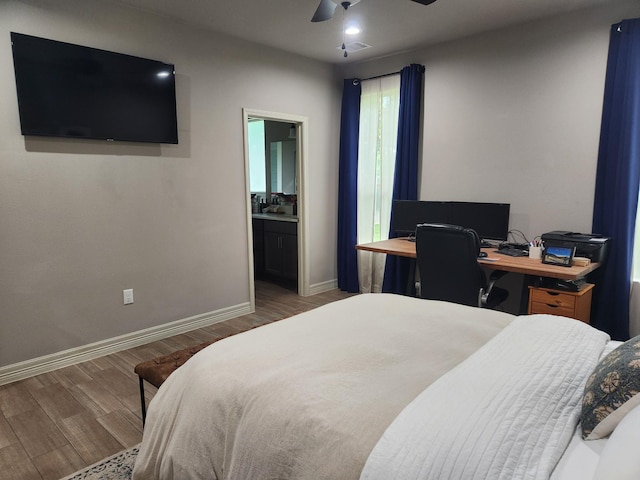 bedroom featuring ensuite bath, ceiling fan, and wood-type flooring