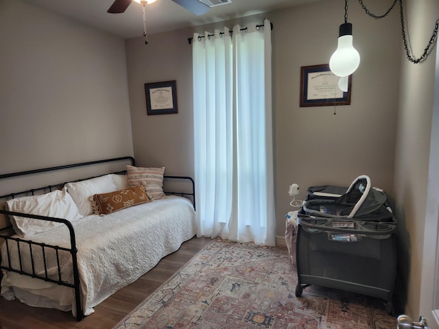 bedroom featuring hardwood / wood-style floors and ceiling fan