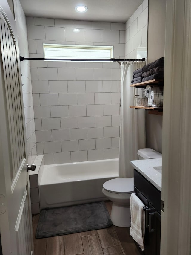 full bathroom featuring shower / bath combination with curtain, vanity, and toilet