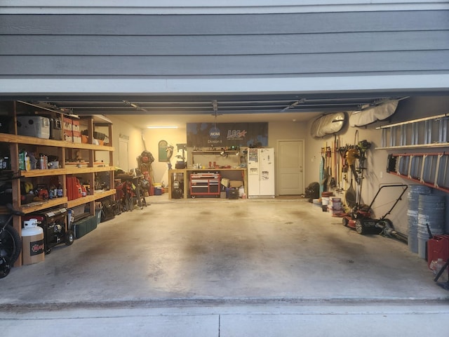 garage with a workshop area and white refrigerator