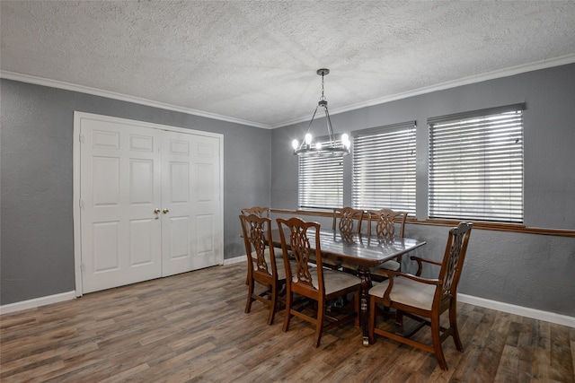 dining room with crown molding, dark hardwood / wood-style flooring, and a notable chandelier