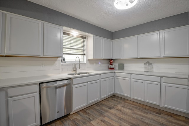 kitchen featuring backsplash, white cabinetry, stainless steel dishwasher, and a textured ceiling