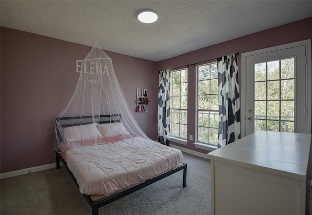 carpeted bedroom with a textured ceiling