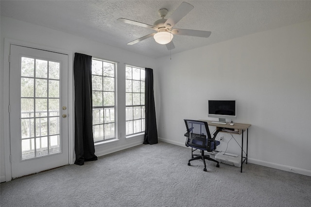 office space featuring ceiling fan, light colored carpet, and a textured ceiling