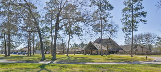 view of property's community with a lawn