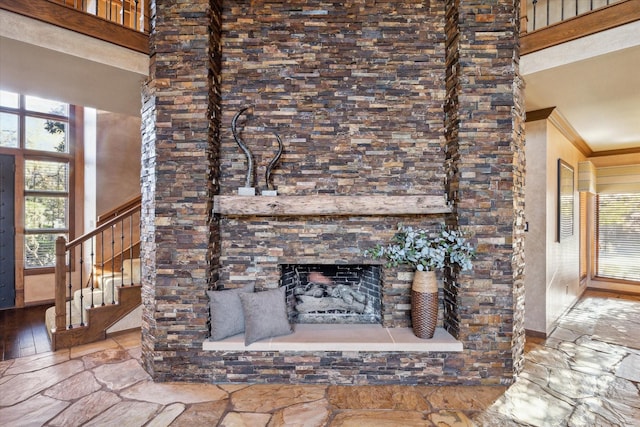 unfurnished living room featuring a fireplace and a towering ceiling