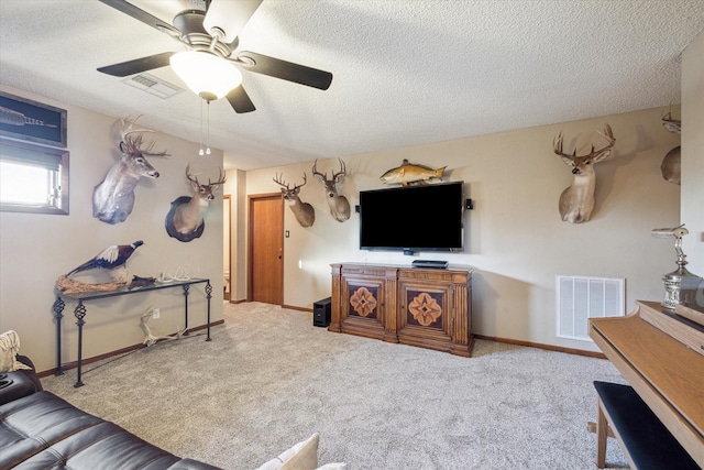 living room with ceiling fan, carpet, and a textured ceiling