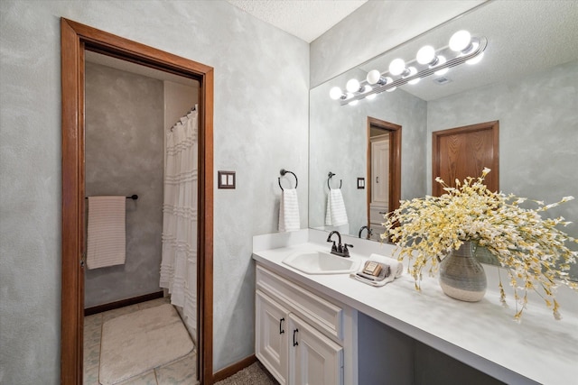 bathroom with vanity and a textured ceiling