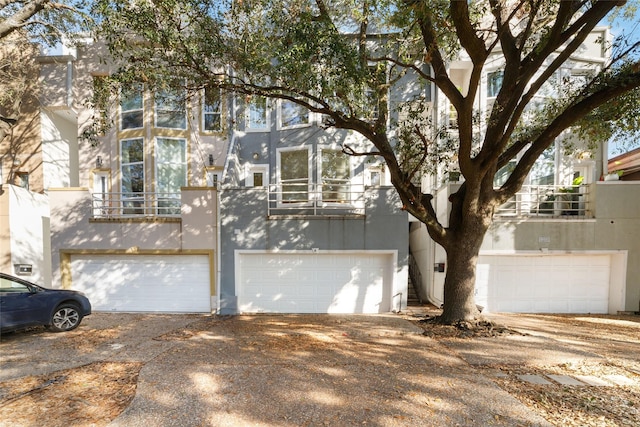 view of front of home with a balcony and a garage