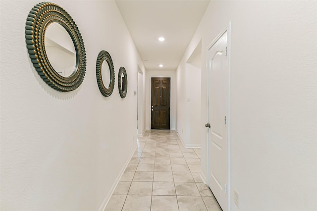 hall featuring light tile patterned flooring