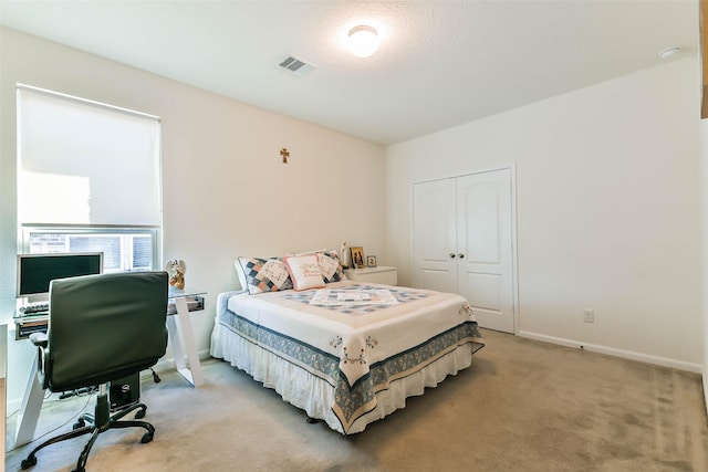 carpeted bedroom featuring a closet