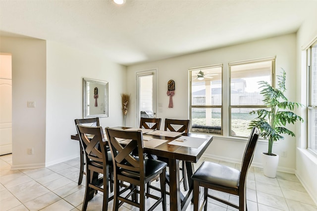 tiled dining area featuring a wealth of natural light and ceiling fan