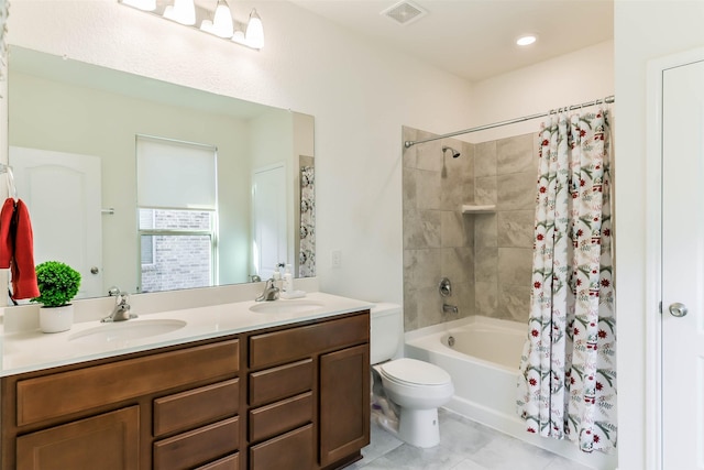 full bathroom featuring tile patterned flooring, vanity, toilet, and shower / bath combo with shower curtain