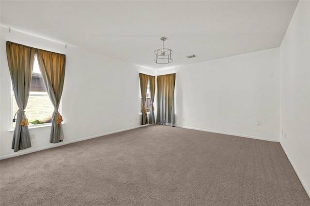 carpeted empty room featuring a wealth of natural light