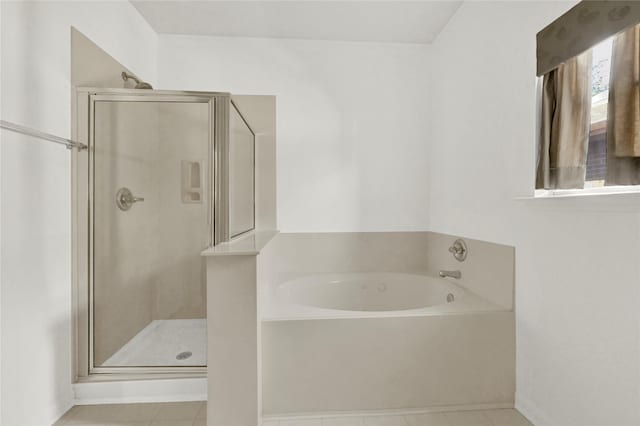 bathroom featuring tile patterned flooring and independent shower and bath