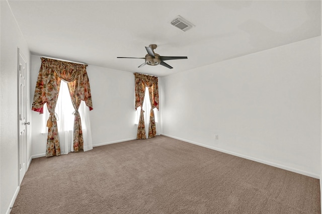 unfurnished room featuring ceiling fan and carpet