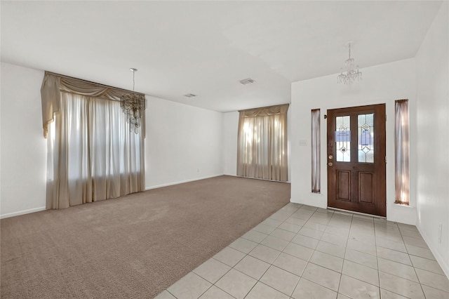 entrance foyer featuring light carpet and a notable chandelier