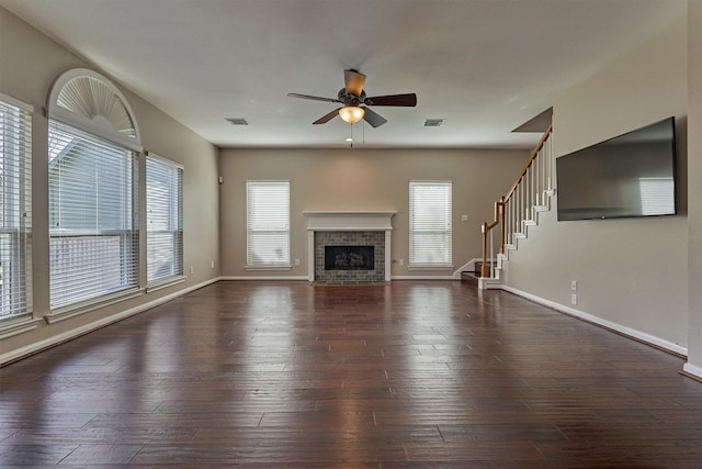 unfurnished living room with dark hardwood / wood-style flooring, ceiling fan, and plenty of natural light