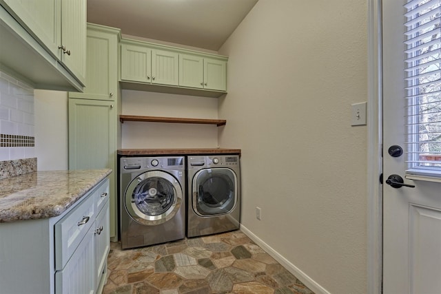 laundry room with cabinets and washing machine and clothes dryer