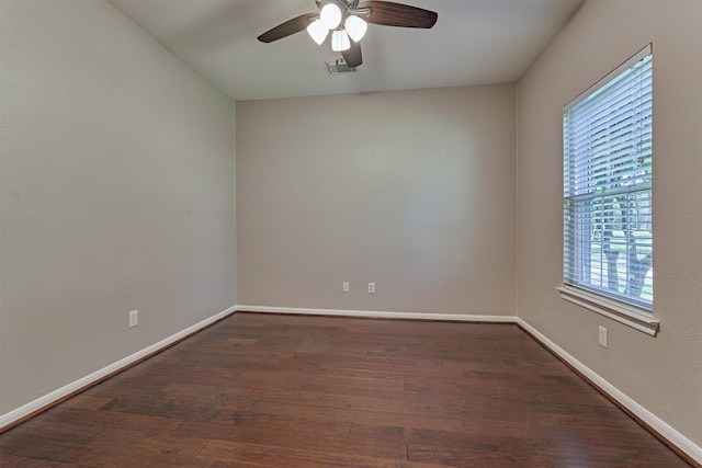 spare room with dark hardwood / wood-style floors and ceiling fan