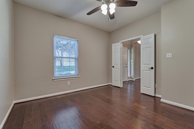 empty room featuring dark hardwood / wood-style floors and ceiling fan